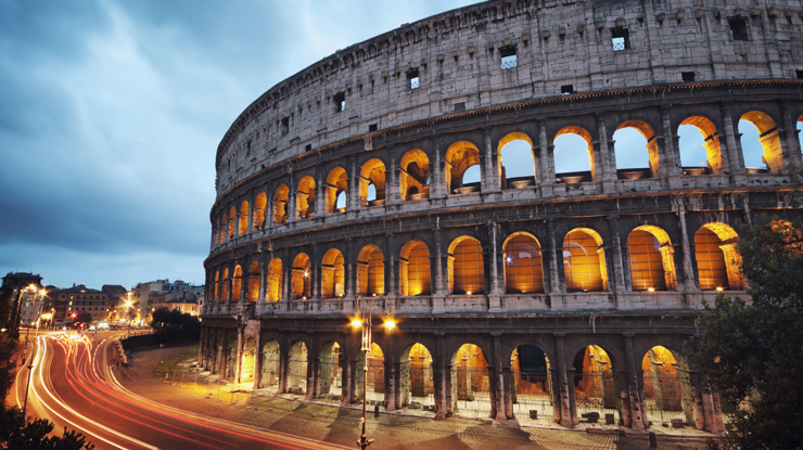 Roman coliseum with streaks of car lights driving below